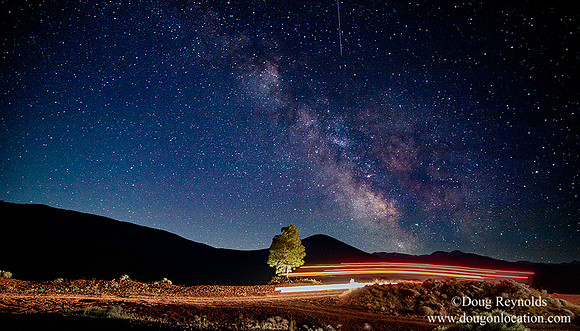 Truck light trails under the milky way
